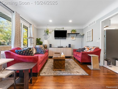 Living area featuring wood finished floors and recessed lighting