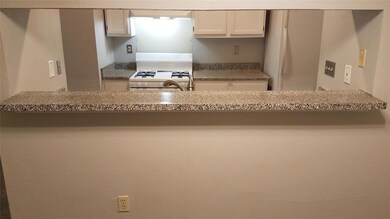 Kitchen featuring white cabinetry and white range