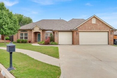 View of front of home with brick siding, a garage, driveway, a front lawn, and a shingled roof