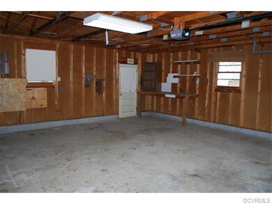 Interior of spacious garage with workbench.