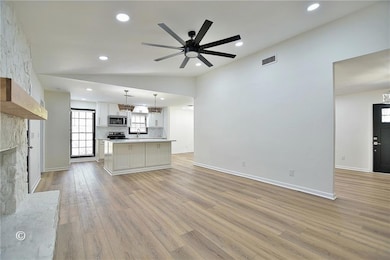 Kitchen with light wood-type flooring, visible ven