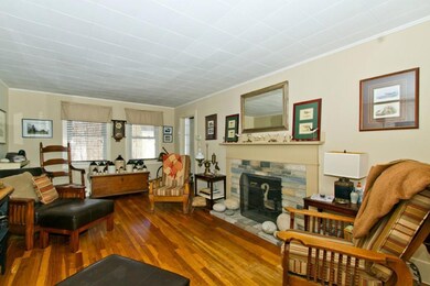 Living room with stone fireplace.