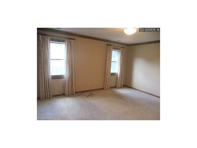 The master bedroom is featured off of the den with
