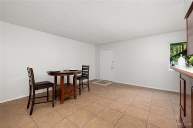 Tiled dining room with a textured ceiling