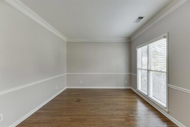 Unfurnished room with dark wood-type flooring and ornamental molding