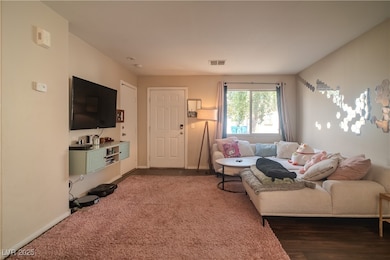 Living room with wood finished floors and baseboar