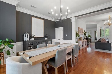 Pretty Dining with wainscoting, columns, crown molding and new chandelier