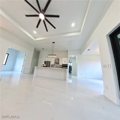 Unfurnished living room with a raised ceiling, a c