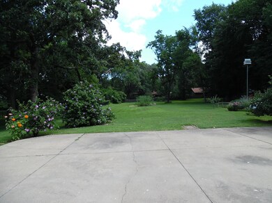 West side of home with parking pad and huge back yard.
