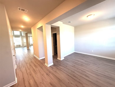 Spare room with baseboards and dark wood-style flooring
