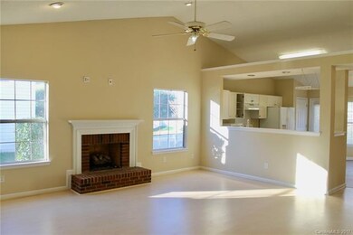 Great room has vaulted ceilings, ceiling fan, can 