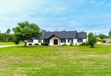 Single story home featuring a front lawn