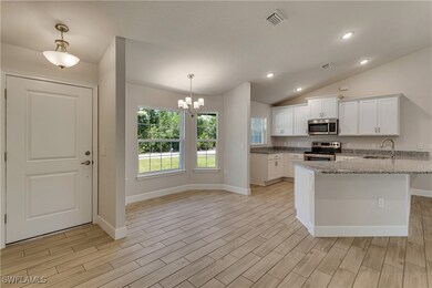 Kitchen featuring visible vents, white cabinets, a