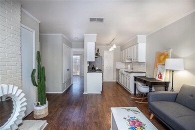 Kitchen featuring white cabinetry, backsplash, da