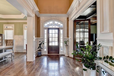 Entryway featuring a decorative wall, ornamental m