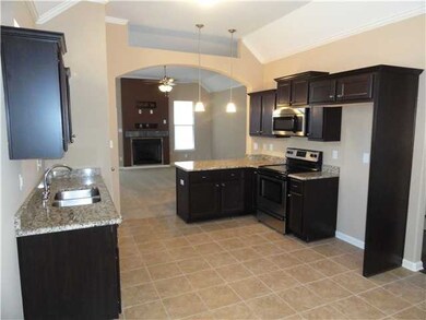 Kitchen with granite counter tops and stainless steel appliances.