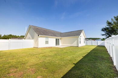 Back of property with a yard and a patio area