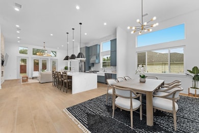Dining area with a chandelier, light wood finishe