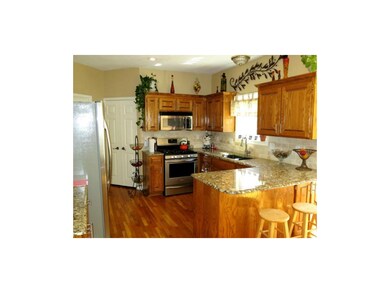 View of spacious kitchen showing granite counter t