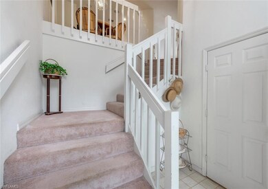 Stairs featuring a towering ceiling and carpet flooring
