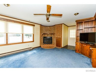 Step Down Family Room with Corner Brick Wood Stove