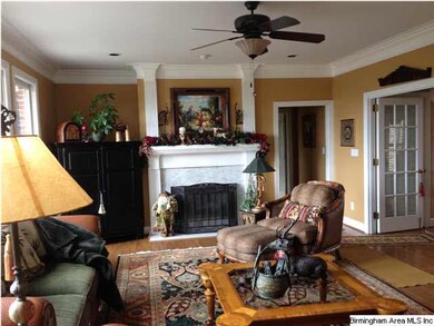 The Family Room with marble fireplace and a wall o