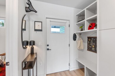 Mudroom featuring light wood finished floors and 