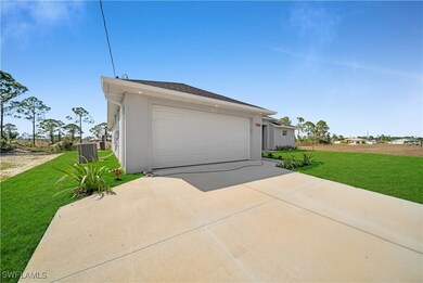 Garage featuring concrete driveway
