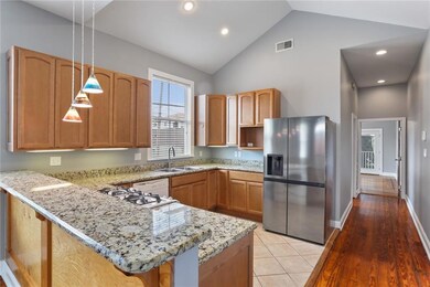 Kitchen open to the living room with tall vaulted