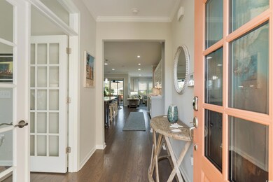 Hall featuring ornamental molding, dark hardwood /