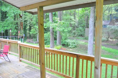 View of backyard and walking trails from roofed ar