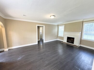 Unfurnished living room with crown molding and dar