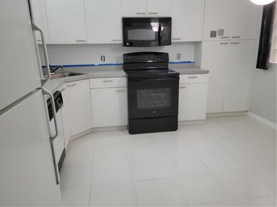 Spacious Eat in Kitchen with White Cabinets & Whit