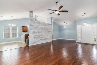 Unfurnished living room with high vaulted ceiling,