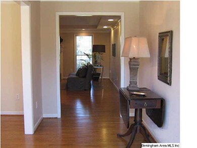 Entry has hardwood floors and view of the dining r