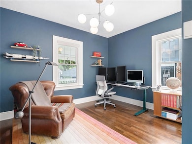 Home office with hardwood / wood-style floors and 