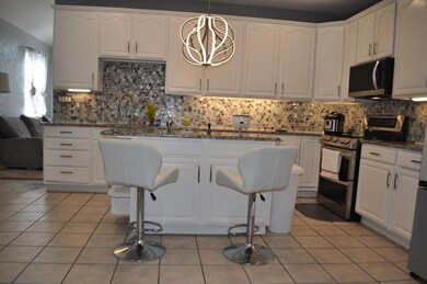 Kitchen with stainless steel appliances, light til