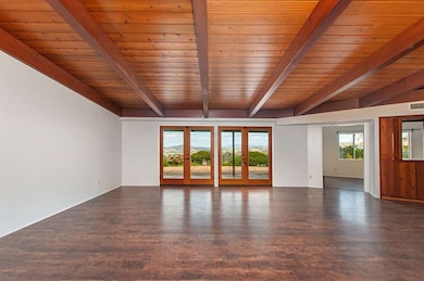 Spacious Living room with wood beam ceilings and v