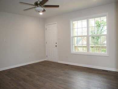Light grey walls and white woodwork. Lots of rooms for comfy furniture and TV.