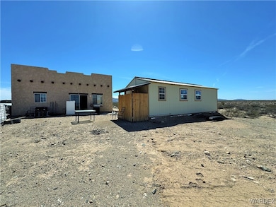 Back of house with an outdoor structure