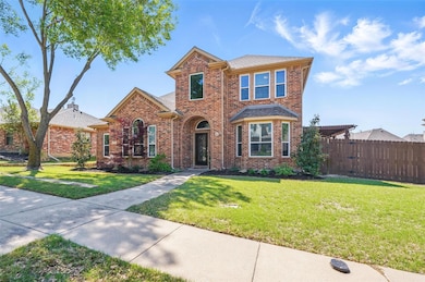Traditional home featuring roof with shingles, a f