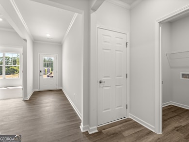 Aria front entryway hallway with access to the garage and laundry room