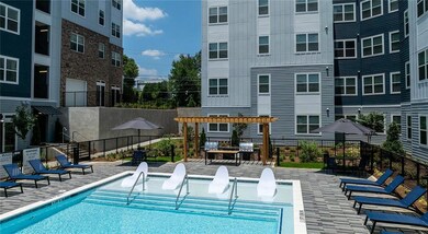 Community pool with a pergola and a patio area