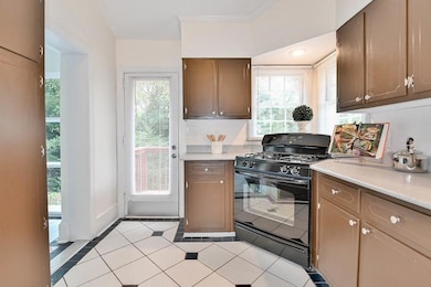 Kitchen featuring gas stove and light tile patterned floors