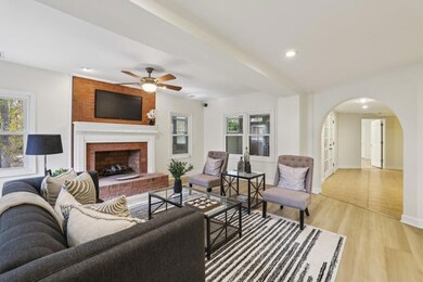 The Daylight Terrace Level expands the living space, boasting a Fireside Family Room with Newly Installed Luxury Vinyl Plank Flooring, a Full Kitchen, and A Sunroom with A Built-In Bar