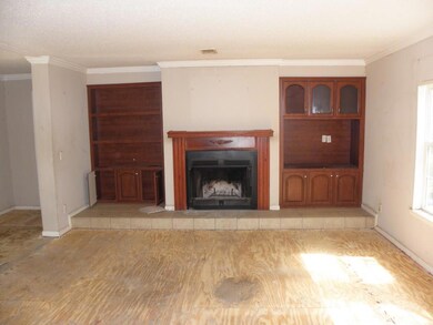 The beautiful bookcases and fireplace in the den.