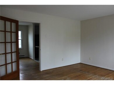 Living room with hardwood floors, French door, and
