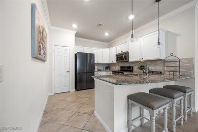 Kitchen featuring dark stone countertops, a sink,