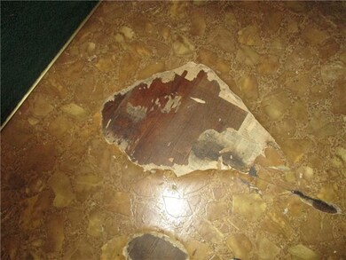 Looks like hardwood flooring, not sure how far it extends.