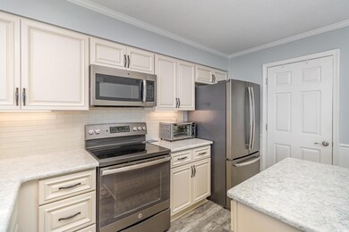 Kitchen featuring crown molding, decorative backsp